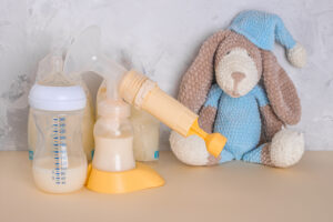 Bags with breast milk. Breast pump on blue background. Milk bank. Expressing breast milk. Breast-feeding. Freezing and storing milk. Donated. Copyspace